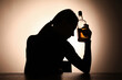 © New Africa - Alcohol addiction. Silhouette of woman with bottle of whiskey at wooden table, backlit