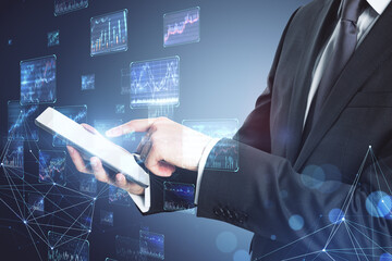 Poster - Close up of businessman hands using tablet with creative forex charts on blurry background. Trade and economy concept. Double exposure.