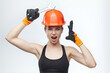 © Vadzim - attractive blonde in an orange protective helmet and a wrench in her hands.