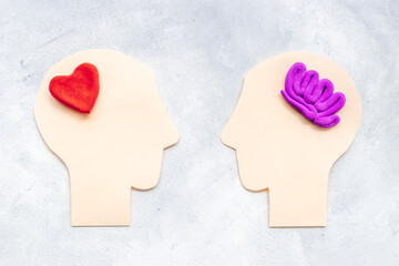 Brain and heart - logic and emotion. Communication between two paper human heads