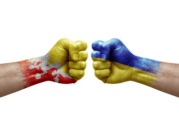 Two hands punch to each others on white background. Country flags painted fists, conflict crisis concept between bhutan and ukraine