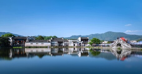 Fototapete - Chinese ancient village in afternoon, beautiful Hongcun was packed with visitors, time lapse