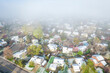 foggy spring morning over residential area of Fort Collins in northern Colorado after heavy rain and snow, aerial view
