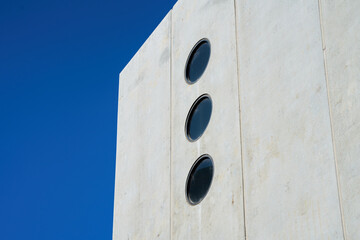 Wall Mural - An exterior view of a building with circle-shaped windows on clear sky background