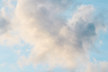 Wall Mural - Background of blue sky with white pink clouds at sunset