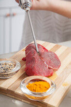 Stainless Steel Meat Injector Being Used In Kitchen With Raw Check And Steak Meat