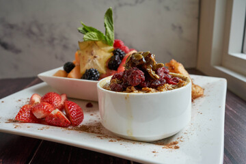 Sticker - A closeup of delicious Oatmeal with Fruits on a white plate