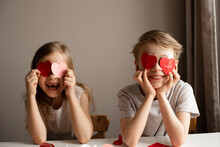 Kids Painting Red Valetine Heart Card On Table At Home
