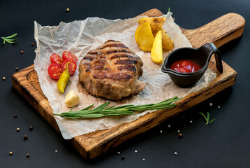 Sticker - Beef steak with twig rosemary and potatoes on a wooden table.