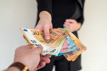 beautiful young female hands holding a lot of euros to invest in business.