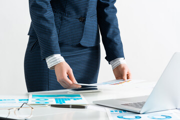 Wall Mural - Woman standing near office desk with laptop