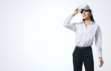 Poster - Virtual reality and technology concept with young woman looking up and VR headset on her head isolated on abstract light background with copyspace, mockup