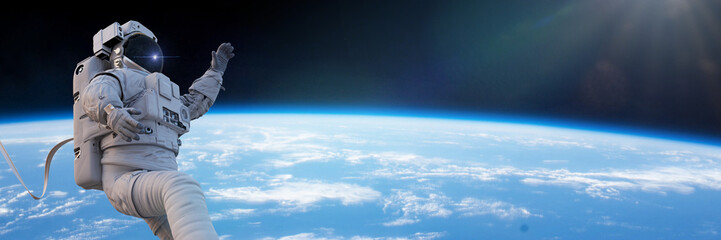 Wall Mural - astronaut during spacewalk in orbit, background banner