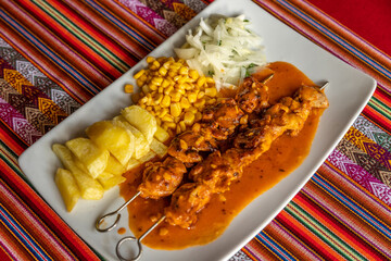 Poster - A closeup shot of saucy barbeque with fried potatoes, corn, and onions on a white plate