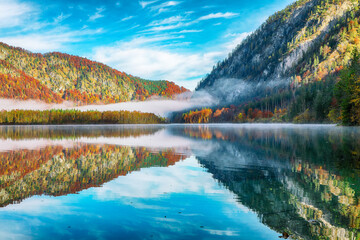 Wall Mural - stunning autumn scene of sunny morning on almsee lake. poppular travell destination.