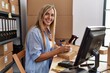 © Krakenimages.com - Young blonde woman ecommerce business worker writing on package at office