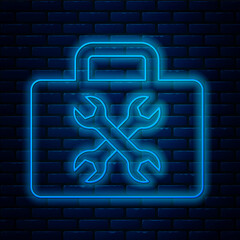 Sticker - Glowing neon line Toolbox icon isolated on brick wall background. Tool box sign. Vector