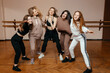 © Кирилл Горшков - Group of girls in sportswear, performing elements of house dance in a dance studio, dancing with pleasure. concept of sports youth