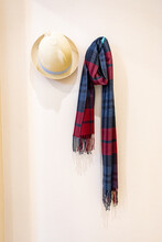 Scarves And Hats Hanging On The Wall.