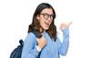 © Krakenimages.com - Young beautiful girl wearing student backpack pointing thumb up to the side smiling happy with open mouth