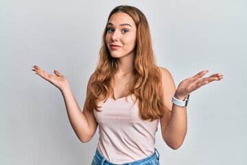 Poster - Young blonde woman wearing casual style with sleeveless shirt clueless and confused with open arms, no idea and doubtful face.