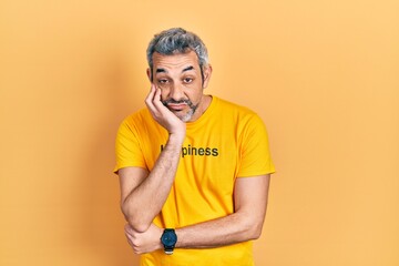 Sticker - Handsome middle age man with grey hair wearing t shirt with happiness word message thinking looking tired and bored with depression problems with crossed arms.