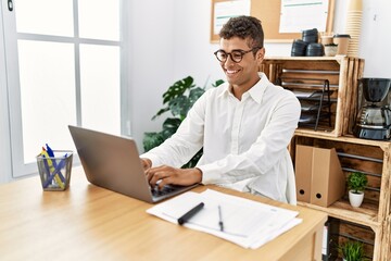 Canvas Print - Young hispanic man working with laptop at business office