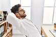 © Krakenimages.com - Young hispanic businessman relaxed with hand on head at the office.