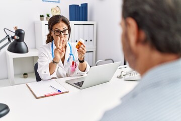 Sticker - Middle age man and woman wearing doctor uniform prescribe pills at clinic