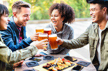 Young Multicultural Friends Drinking And Toasting Beer At Brewery Bar Patio - Youth Life Style Concept With Men And Women Having Fun Together Out Side - Bright Vivid Filter With Focus On Mid Girl