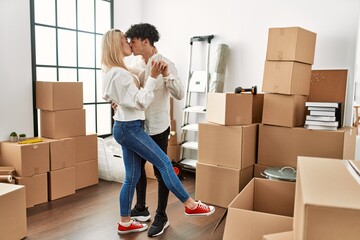 Poster - Young beautiful couple smiling happy dancing at new home