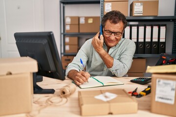 Canvas Print - Middle age man ecommerce business worker talking on the smartphone at office