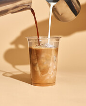 Mockup Of Iced Coffee Milk In A Plastic Cup Inside A Cafe