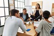 © Krakenimages.com - Businesswoman enjoys meditating during meeting. Sitting on desk near arguing partners at the office.