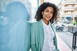 © Krakenimages.com - Young hispanic business woman wearing professional look smiling confident at the city leaning on the wall