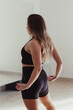 © Esma - Woman stretching out in front of the mirror, in the dance studio, wearing workout clothes.