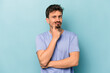 © Asier - Young caucasian man isolated on blue background unhappy looking in camera with sarcastic expression.