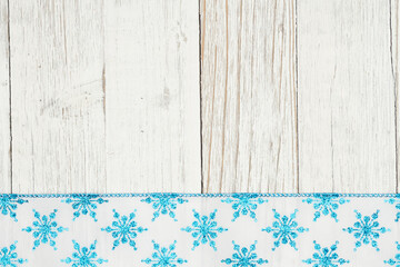 Canvas Print - Blue and white snowflake border winter background with weathered wood