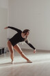 © Esma - A woman standing in a dance pose in a dance studio, dressed in a dance outfit.