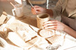 Cropped shot of unrecognizable woman making a cup at pottery class, copy space