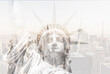 Double exposure of Manhattan skyline in new york city with statue of liberty silhouette