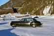 A vintage car and private jets in the airport of Engadine St Moritz