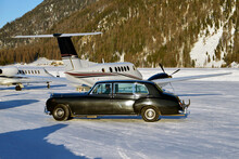 A Vintage Car And Private Jets In The Airport Of Engadine St Moritz
