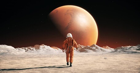 male astronaut in space suit walking on alien planet. planet mars is visible. space related slow mot