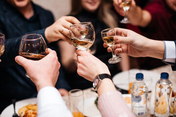 Russian wedding, guests hold glasses with alcohol and are being minted