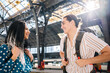 © Cavan Images - Cheerful diverse couple on railroad station