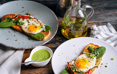 Wall Mural - delicious and appetizing bruschetta with fried eggs and herbs for breakfast