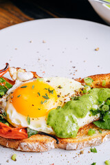 Poster - delicious and appetizing bruschetta with fried eggs and herbs for breakfast