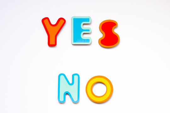 Yes and No words made of colorful wooden toy letters on white background. Choice yes or no concept.