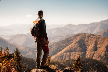  Young traveler hiking girl with backpacks. Hiking in mountains. Sunny landscape. Tourist traveler on background view mockup. High tatras , slovakia